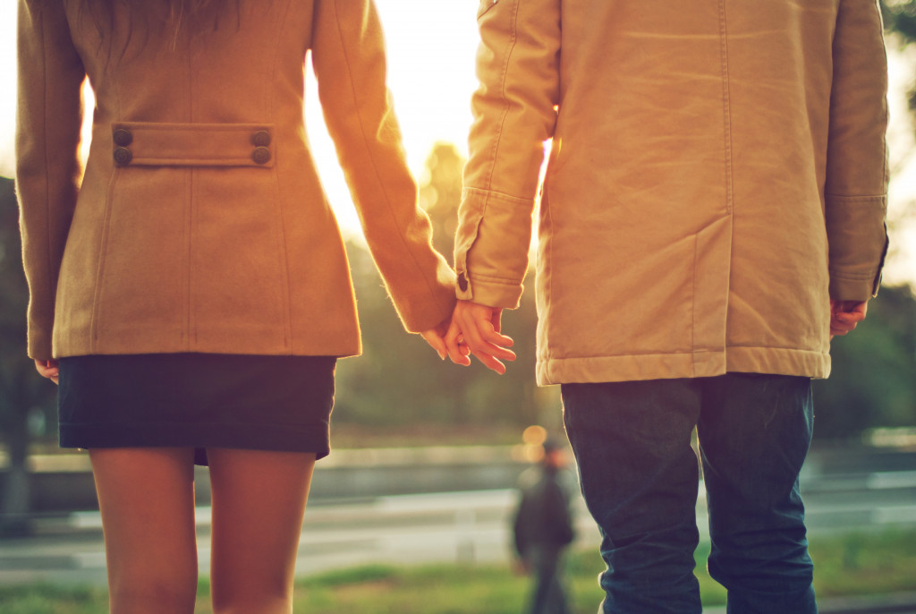 A couple holding hands in the park