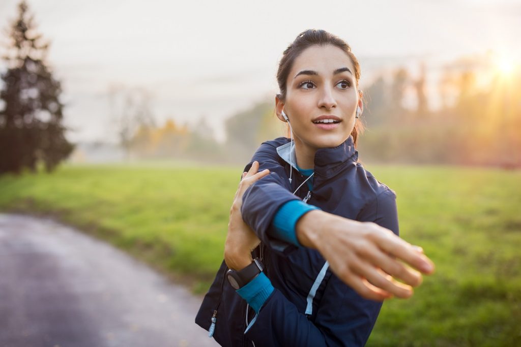 woman stretching at park