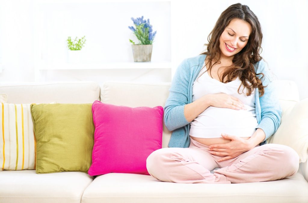 pregnant woman rubbing her baby bump