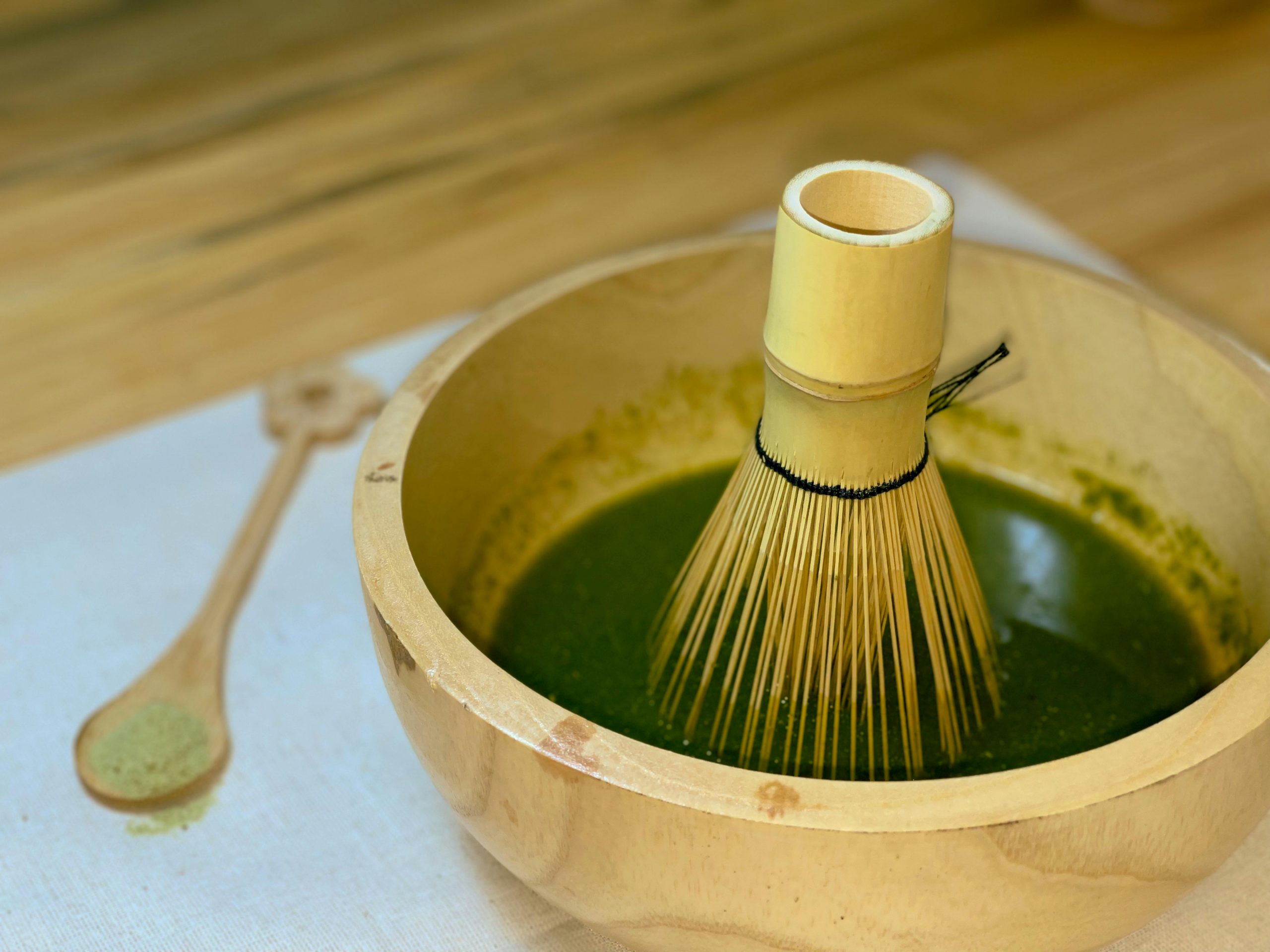 whisk in a bowl of matcha